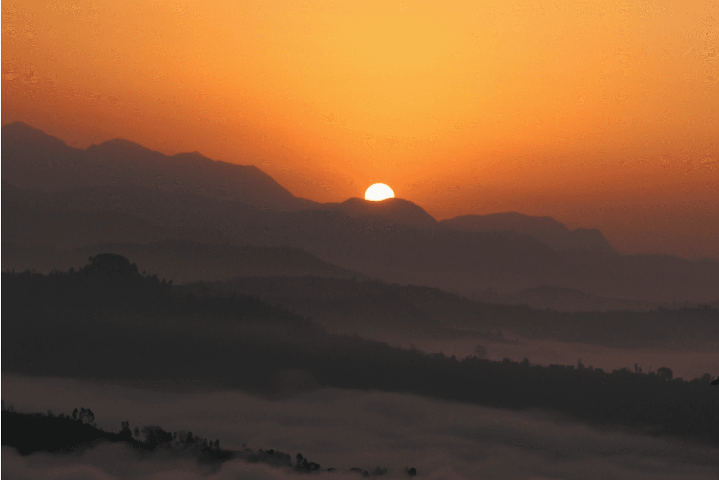 sunset behind mountains landscape